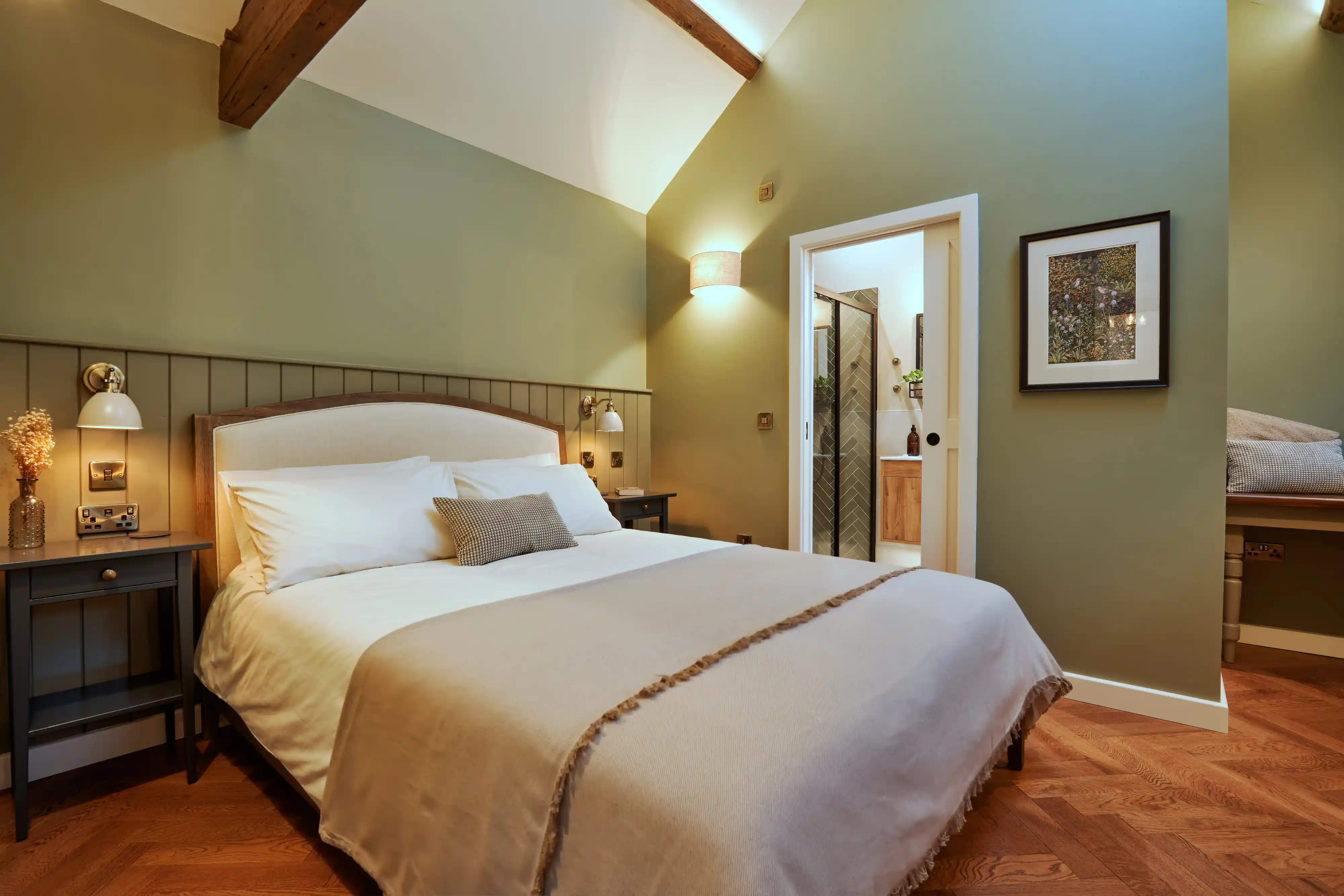 Cozy bedroom featuring a comfortable bed and en-suite bathroom access