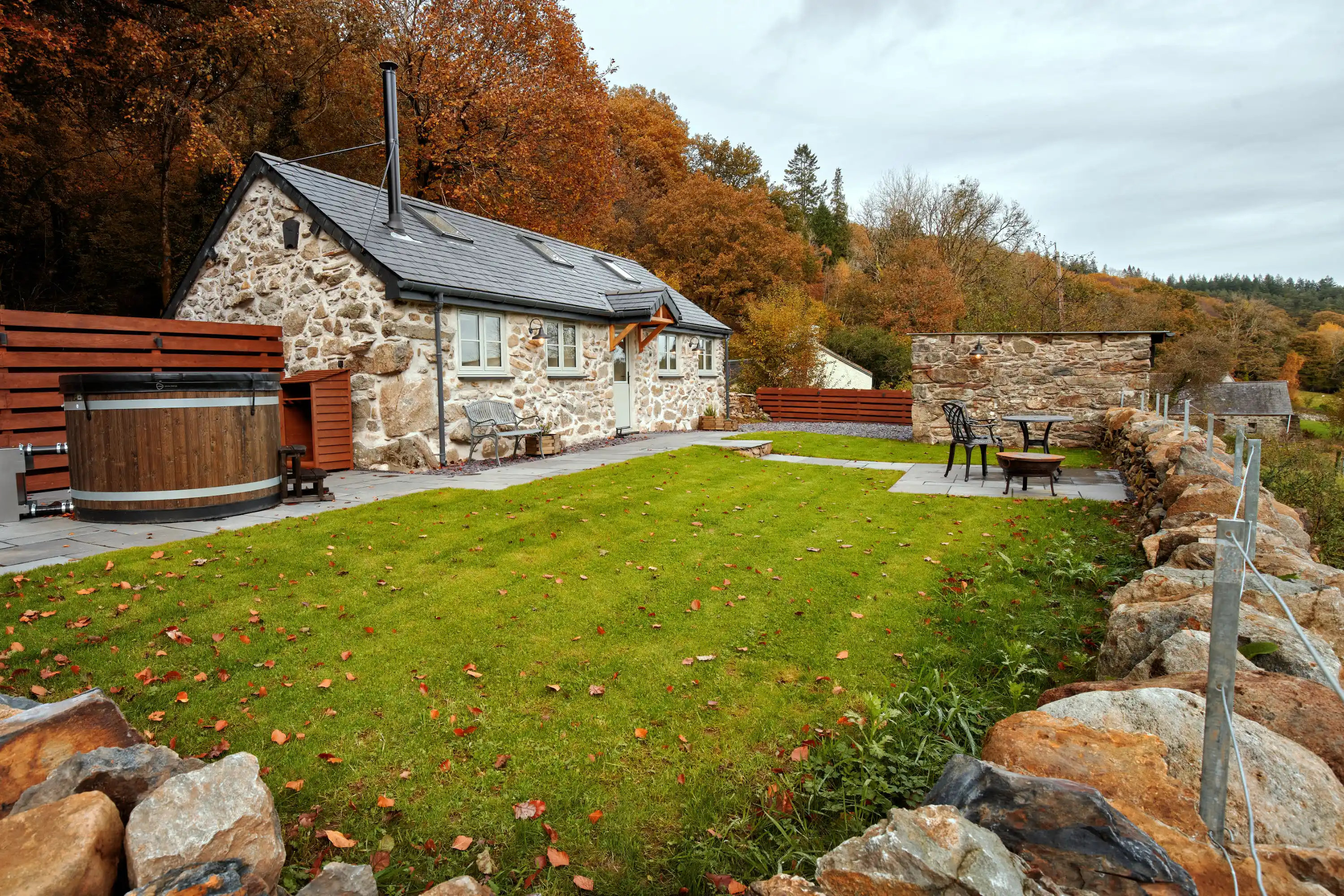 Exterior view of Coed Llydan from the lawn, showcasing the architecture and surroundings