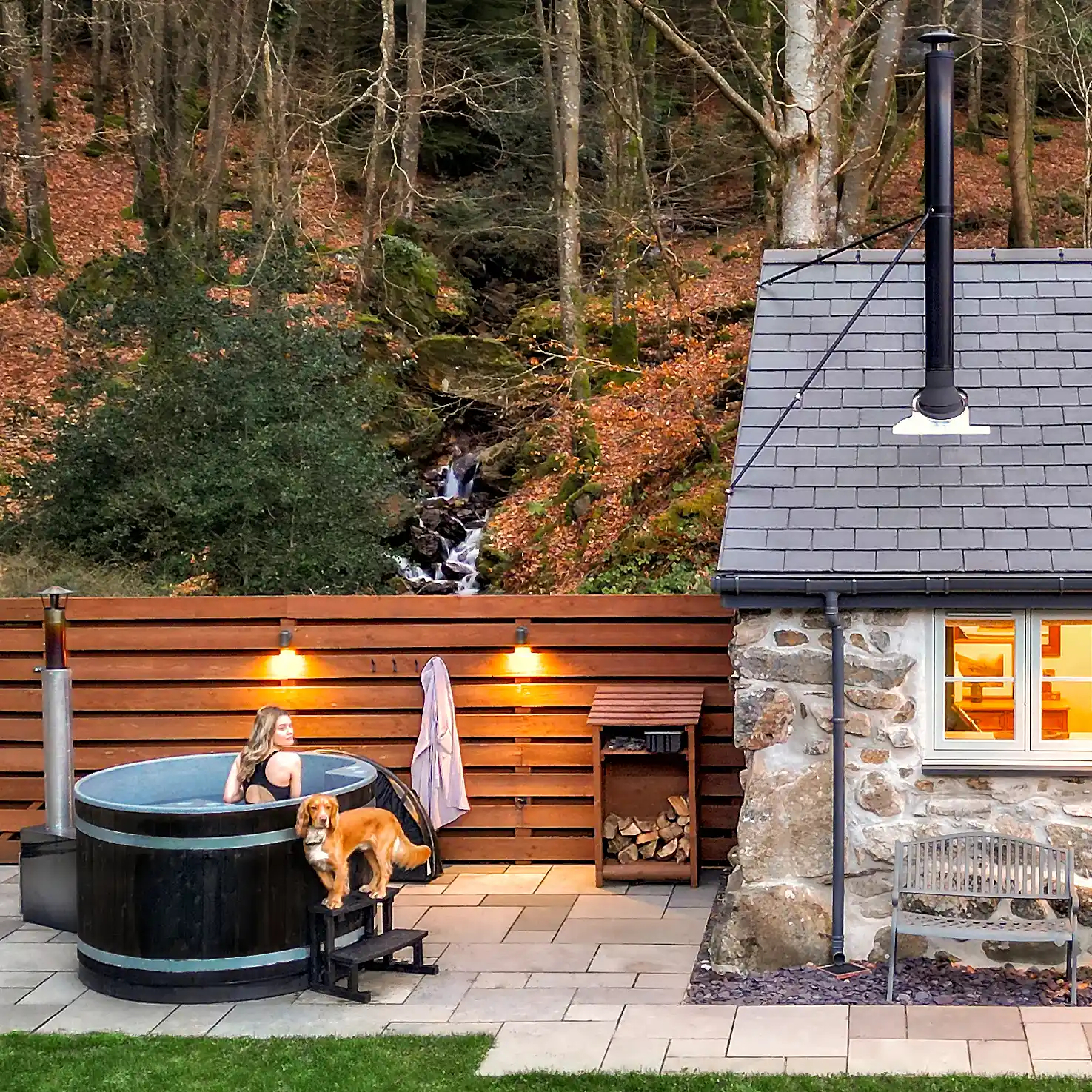 Guest relaxing in the hot tub at Coed Llydan